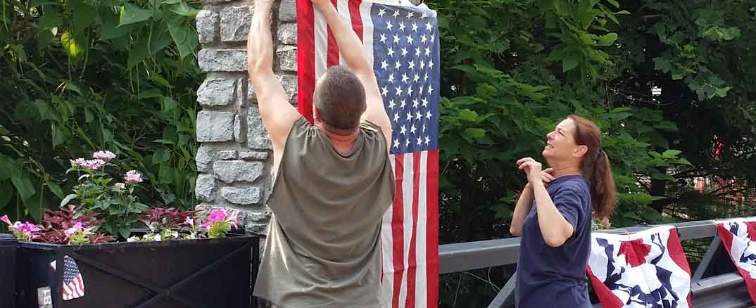 Carpenters decorate Wall Street Bridge for Independence Day