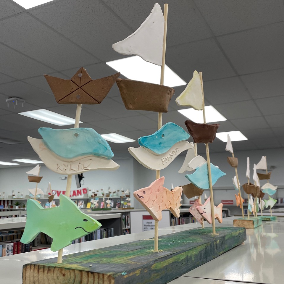 Making boats, fish, and waves at Whistle Stop Clay Works exhibition at Loveland Library